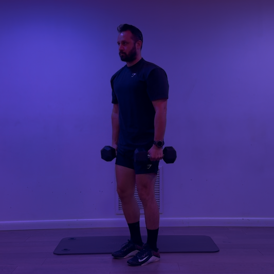 Man exercising with dumbbells in a room with blue lighting